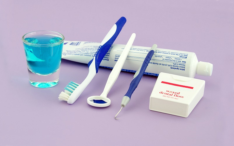 A small assortment of dental health equipment that a person can use at home.